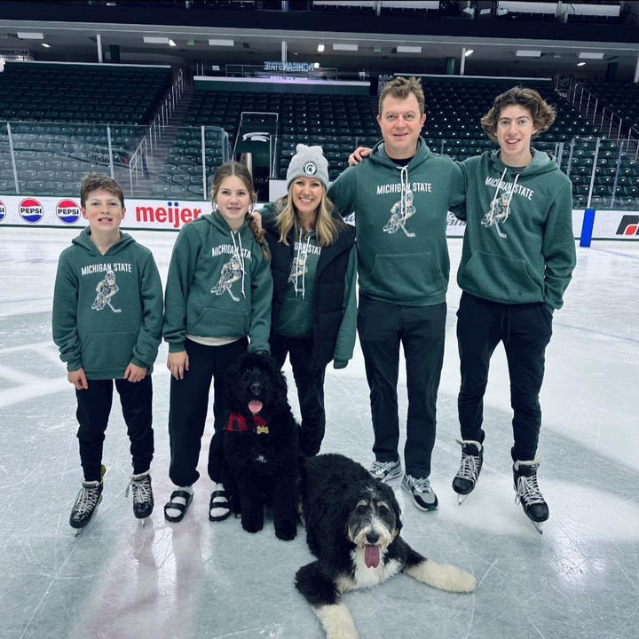Adam Nightingale's Family on ice rink wearing Hockey Sparty Michigan State sweatshirts from Nudge Printing