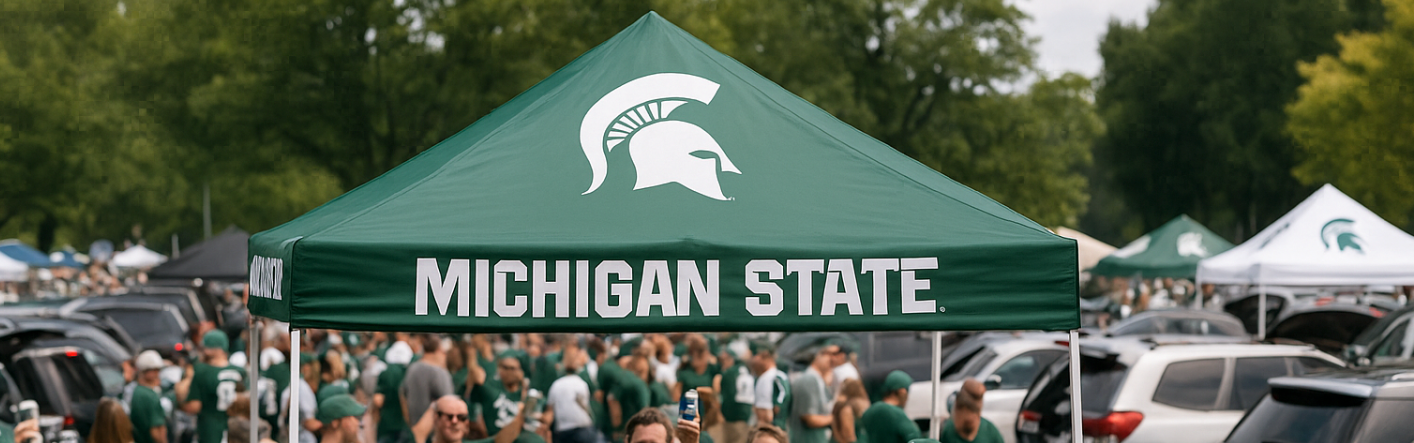 Green Michigan State tent with people and cars in the background