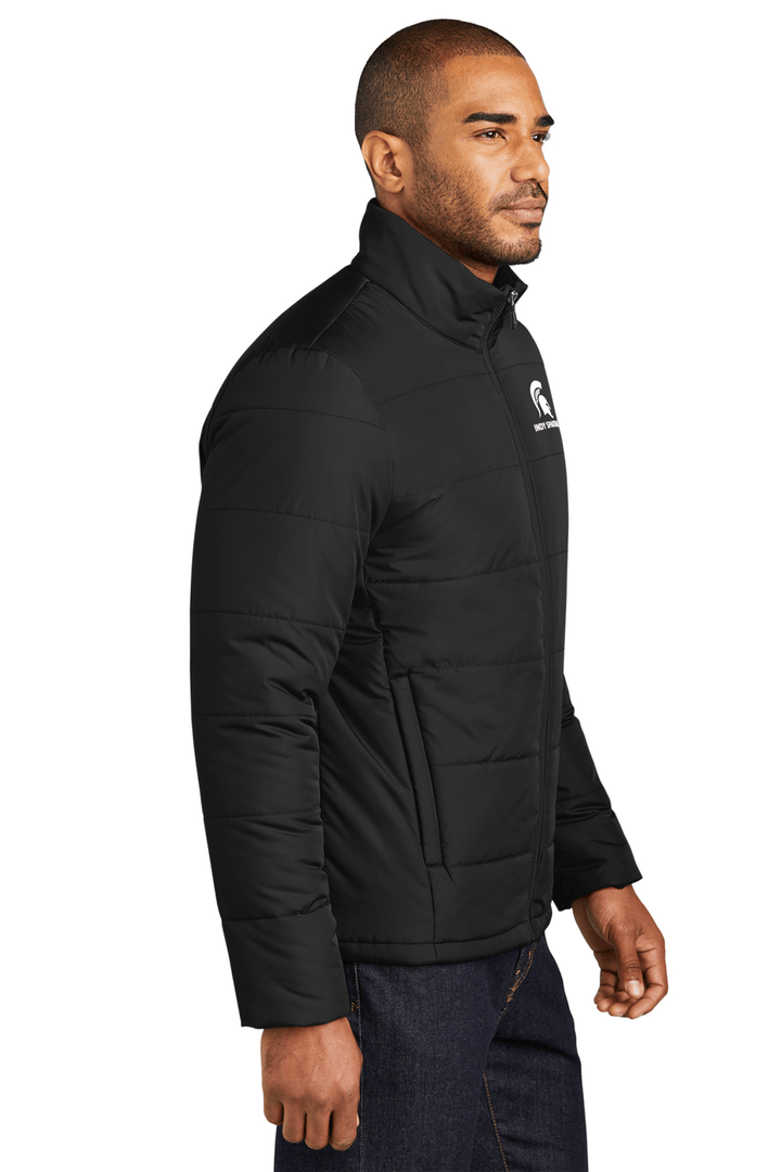 Side view of a black Michigan State puffer jacket with the Indy Spartans Alumni Club logo embroidered in white thread on the left chest.