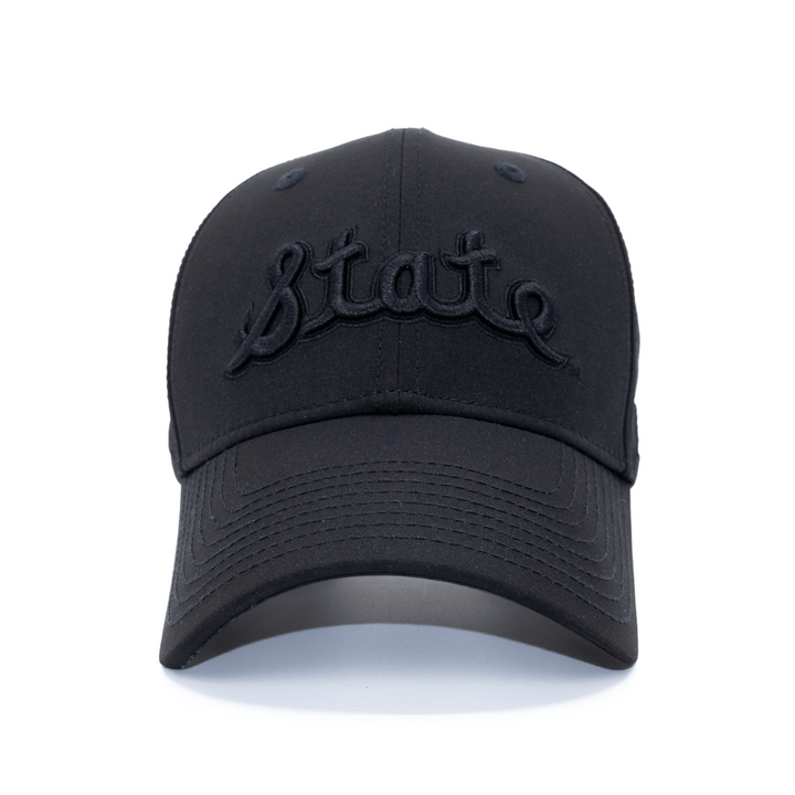 Front view of Michigan State all black State Script hat from Nudge Printing