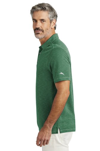 Michigan State Tommy Bahama Branded Polo embroidered on left chest with white Spartan Helmet logo from Nudge Printing Side view of Male Model wearing Polo