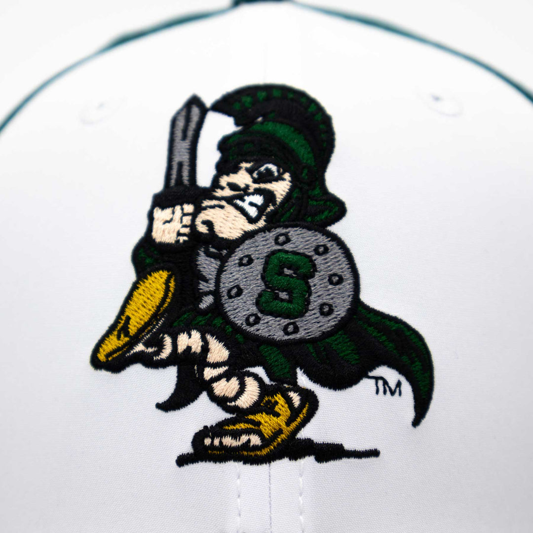 Close up view of a Michigan State vintage Sword Sparty embroidered logo on a hat.