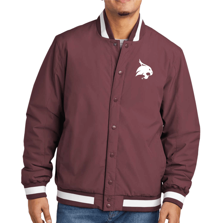 Male model wearing a maroon Texas State varsity jacket with a white bobcat logo embroidered on the left chest.