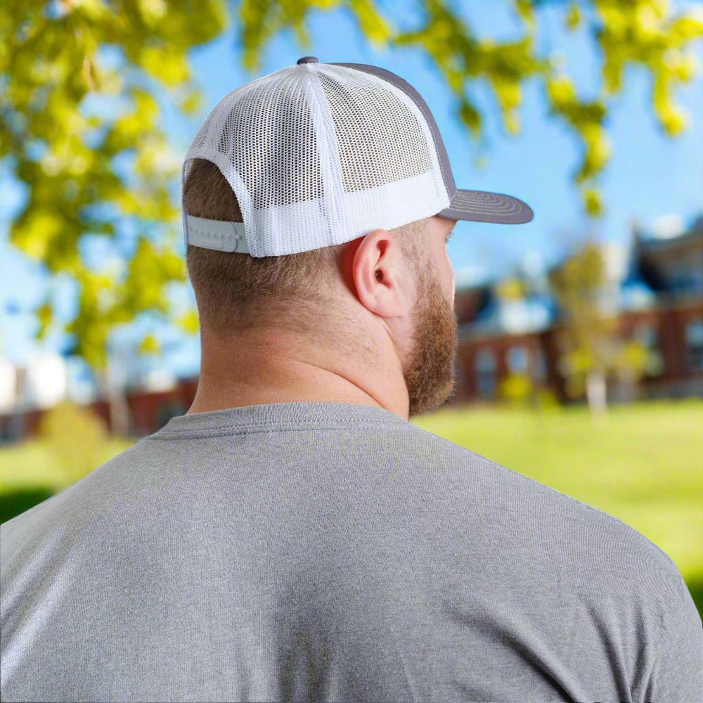 Back view of Kansas State University Powercat Logo Trucker Hat on male model on campus