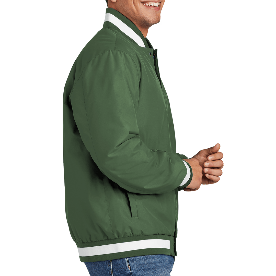Side view of a male model wearing a green varsity jacket from Nudge Printing