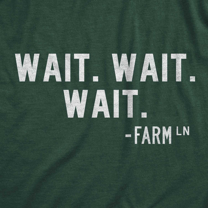Close up of green t-shirt featuring "Wait Wait Wait" printed in white.