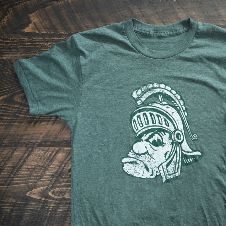 Green Gruff Sparty T Shirt on wood background