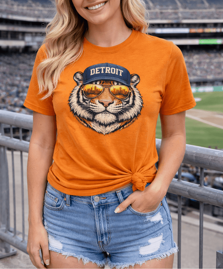 Blonde women wearing an orange Detroit shirt at a baseball game
