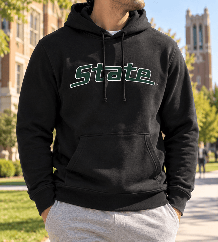 Man in a black Michigan State Hoodie on campus in East Lansing with grey sweatpants