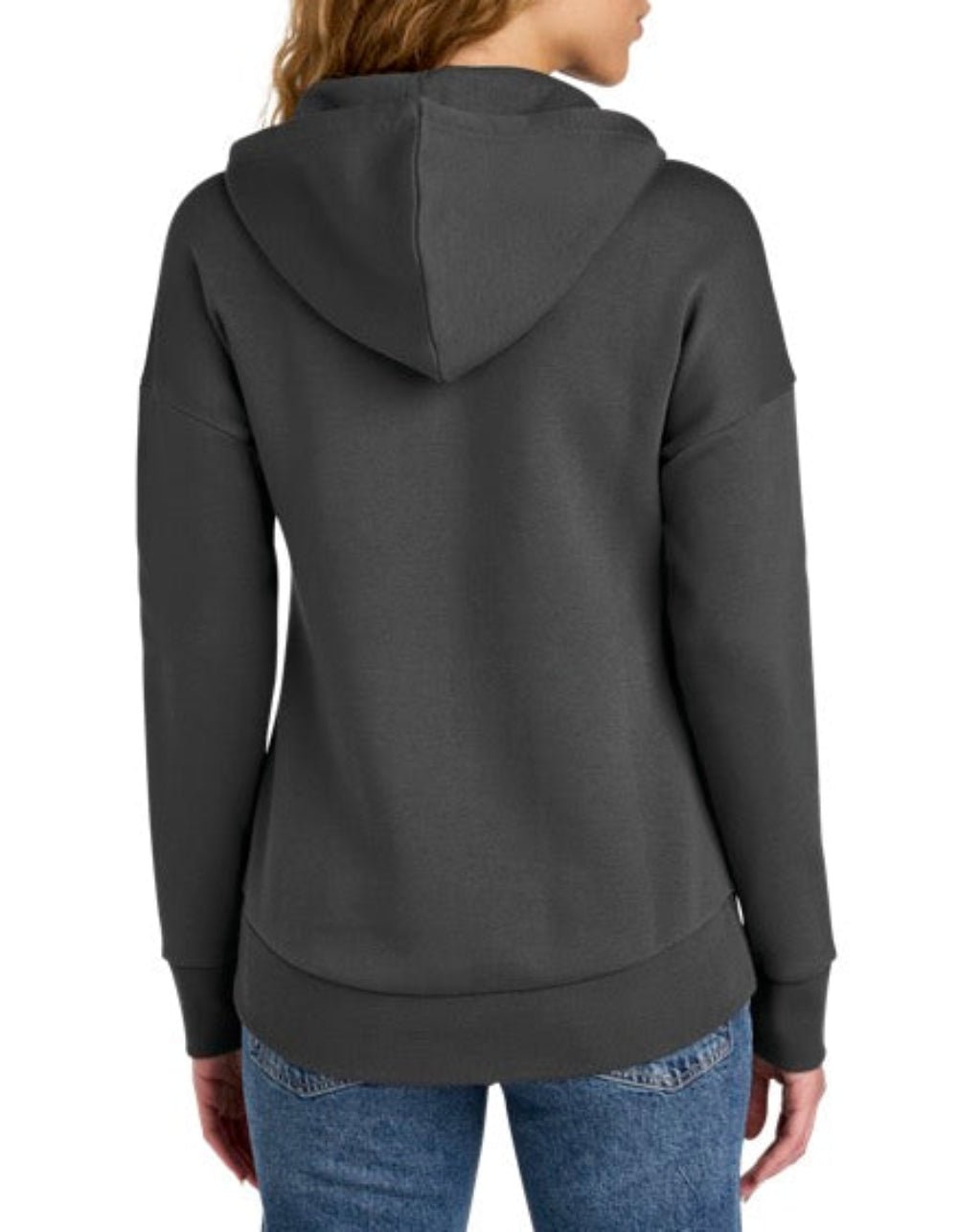 A woman viewed from the back wearing a dark charcoal gray pullover hoodie and blue jeans against a plain white background.