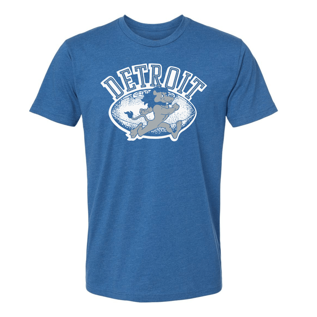 Heather blue Detroit football t-shirt with white distressed football graphic and vintage cartoon running lion, shown on white background
