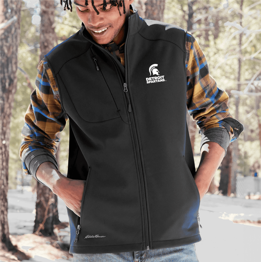 Michigan State Eddie Bauer Black Vest with embroidered Detroit Spartans Logo on left chest with white thread on male model in forest