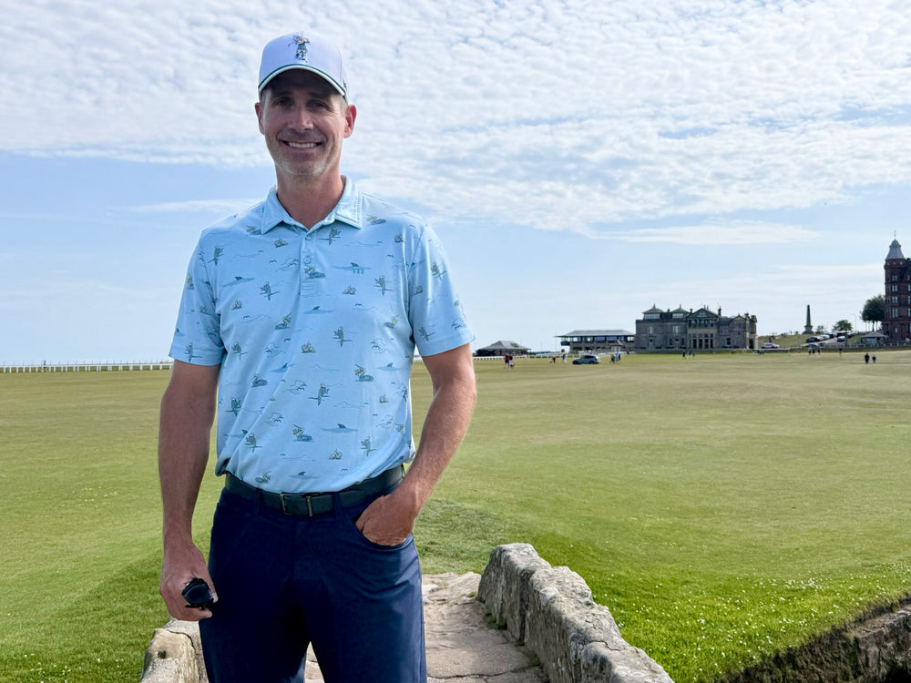 Male model wearing the white Michigan State Golfing Sparty hat on the Old Course at St. Andrews in Scotland with the historic clubhouse in the background.