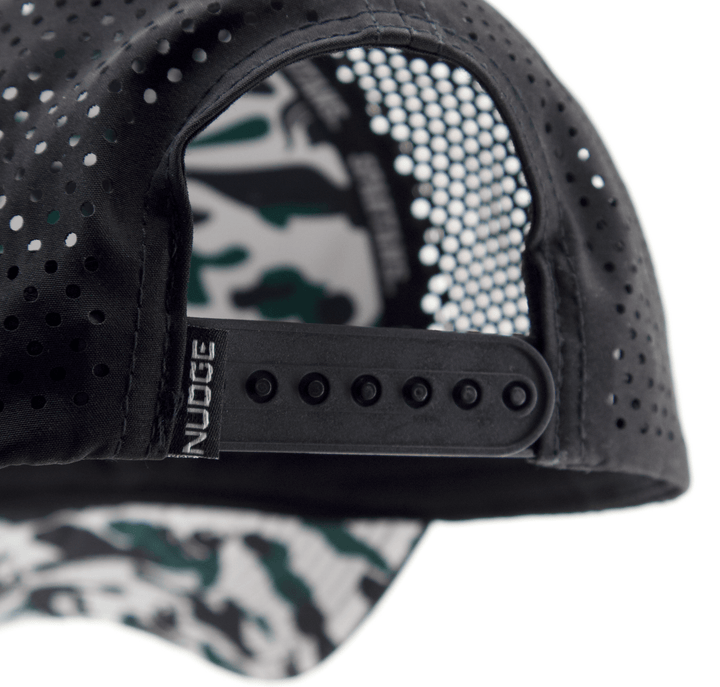 Close up view of a Nudge Printing hat showing the snapback adjustable closure and "Nudge" tag