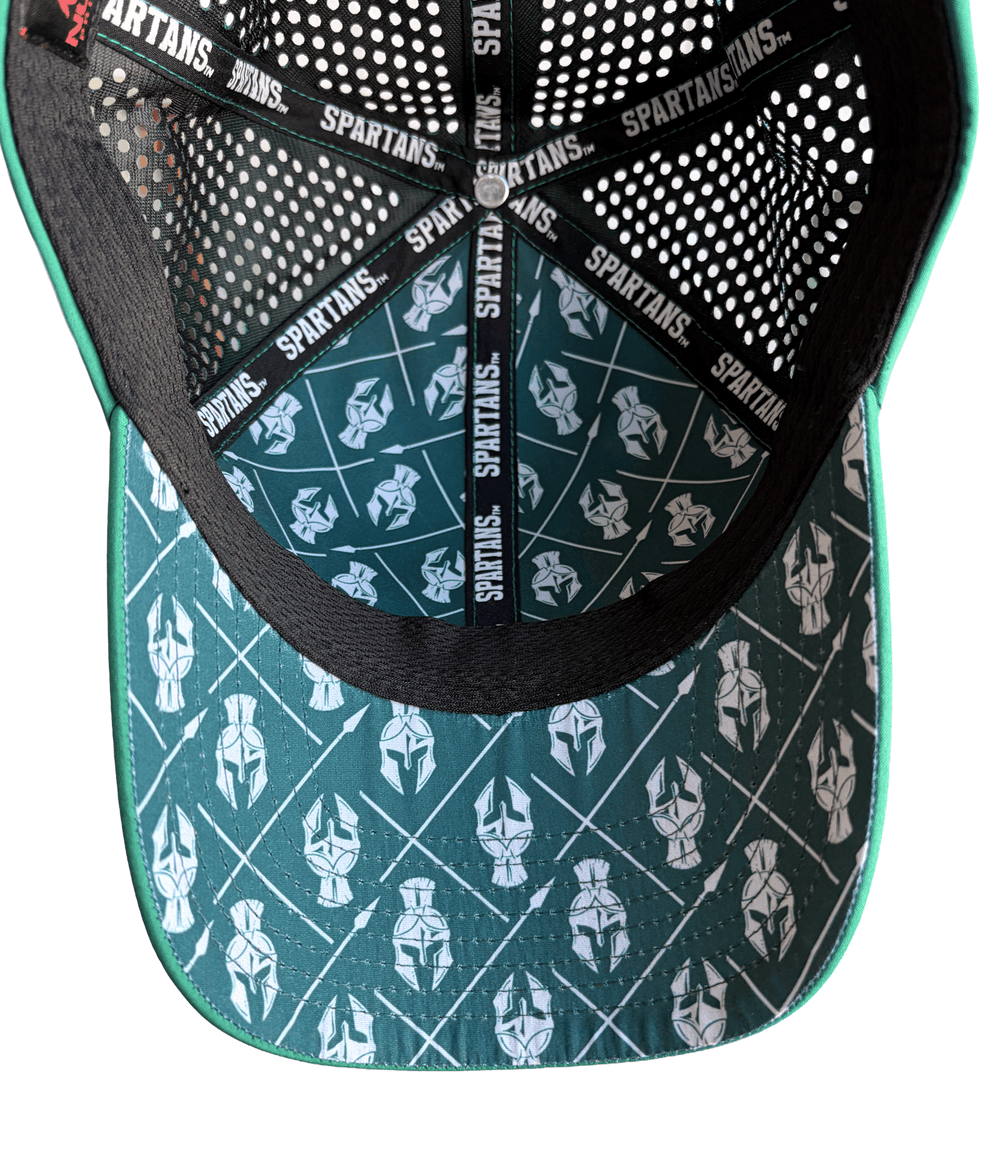 Inside view of Michigan State hat showing dark green underbill and lining printed with white Spartan helmets and crossed spears, black mesh, and Spartans seam tape.