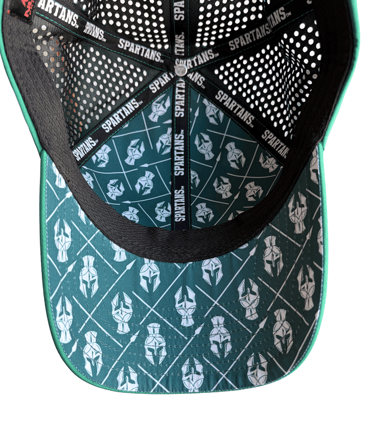 Inside view of Michigan State hat showing dark green underbill and lining printed with white Spartan helmets and crossed spears, black mesh, and Spartans seam tape.