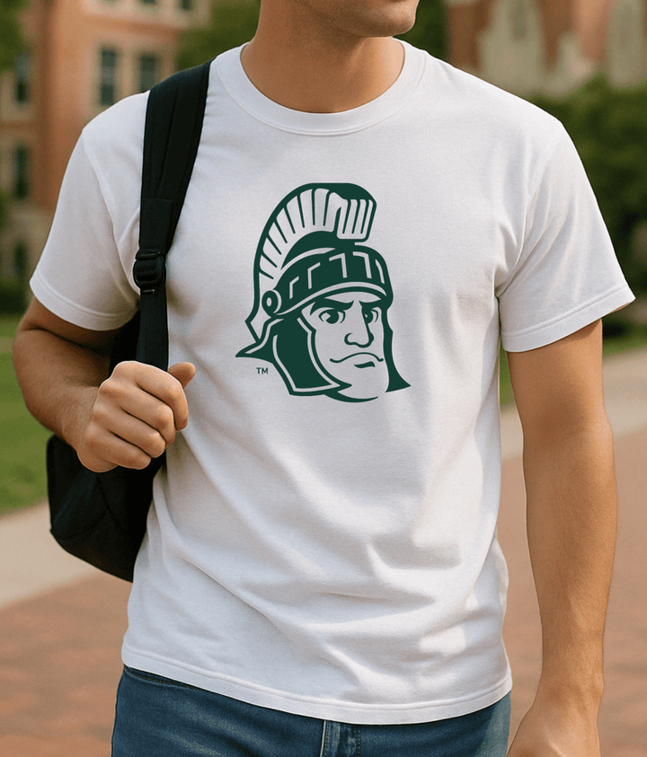 Michigan State White Shirt with Sparty Head Logo on male college student wearing a black backpack on campus