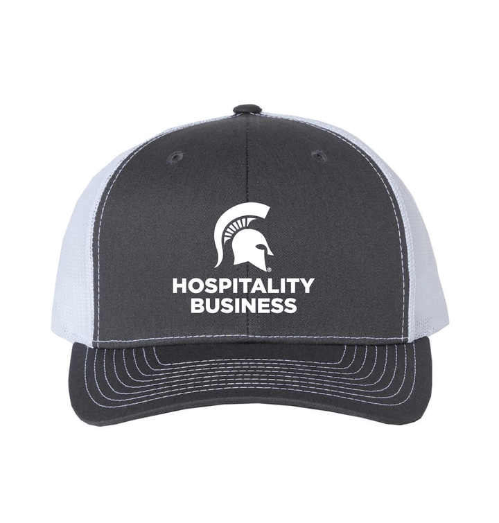 Charcoal and white Michigan State Hospitality Business trucker hat with embroidered Spartan helmet logo and Hospitality Business wordmark on the front panel.