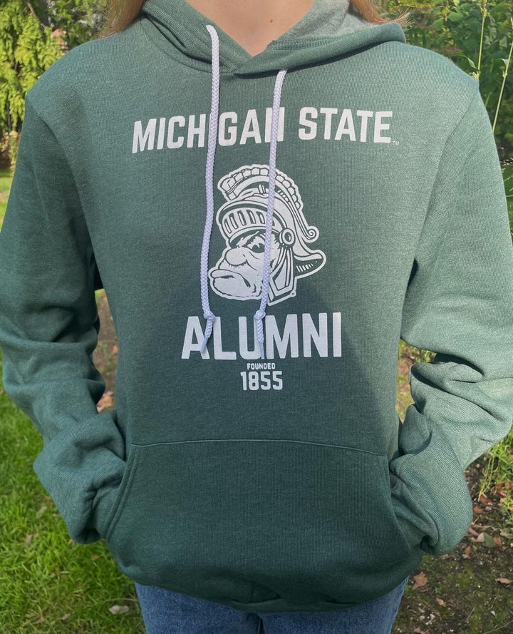 Michigan State Alumni Sweatshirt with Gruff Sparty on Student standing on Campus of MSU