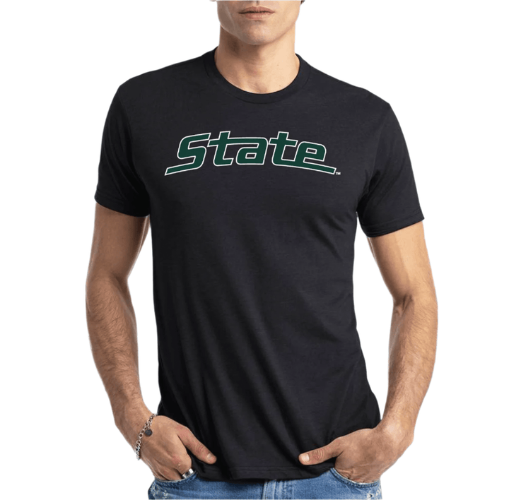 Male model wearing a black Michigan State t-shirt with the iconic "State" arched logo printed across the chest in white and green ink. 
