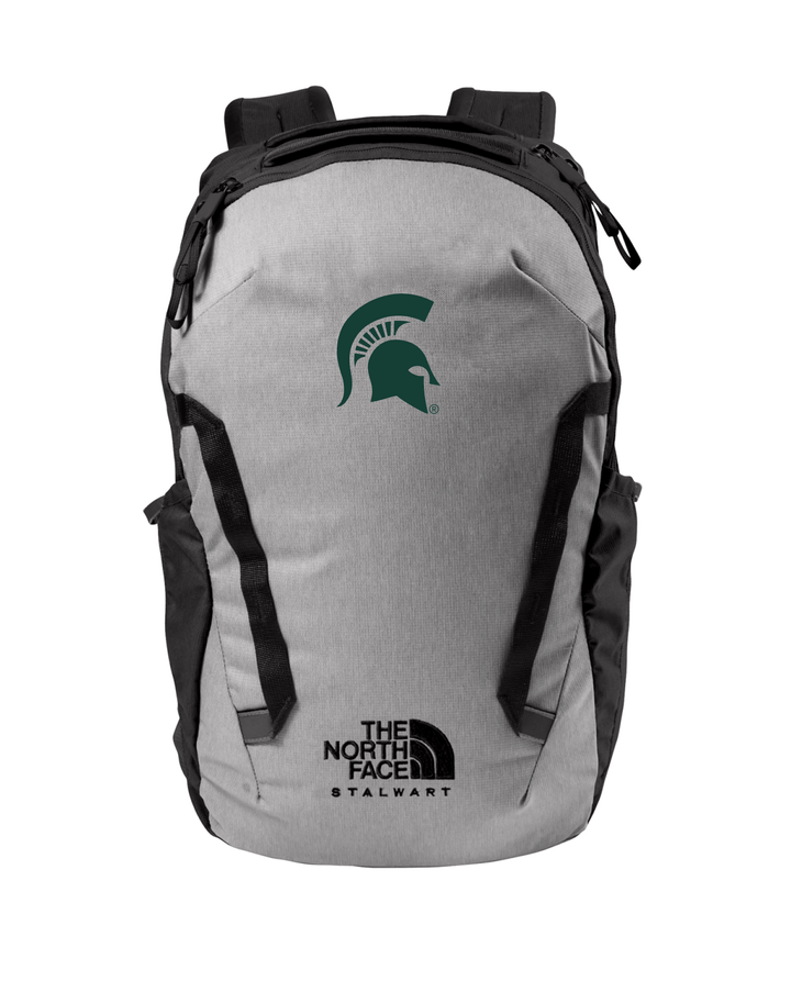 Front view of a Michigan State grey North Face backpack which has a green Spartan Helmet embroidered on the front. 