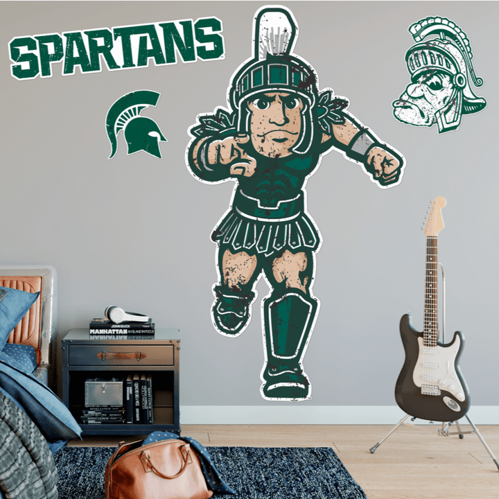 In person shot of Michigan State lifesize Gruff Sparty wall decal pointing to camera.