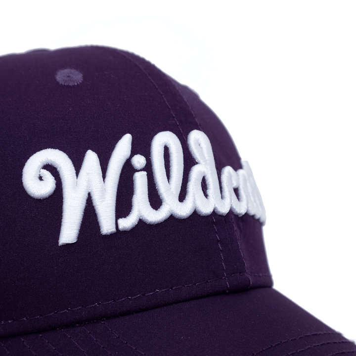 Close up view of purple Kansas State hat with Wildcats embroidered in white thread on the crown.