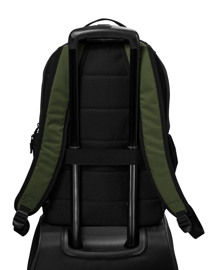 Green Michigan State backpack strapped to luggage.