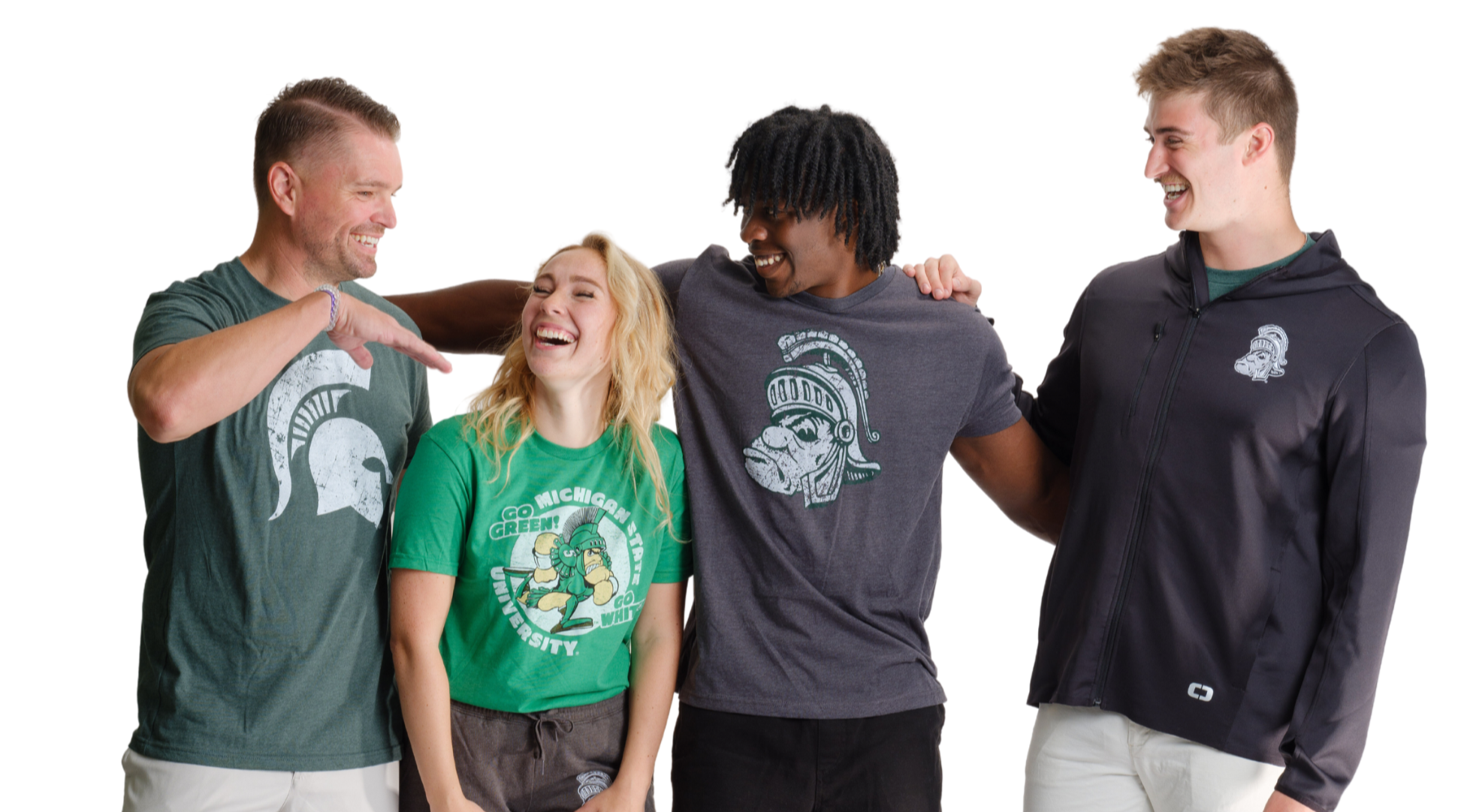 Group of Michigan State fans wearing officially licensed MSU apparel including Gruff Sparty and Spartan Helmet designs, standing and laughing in casual gear on white background