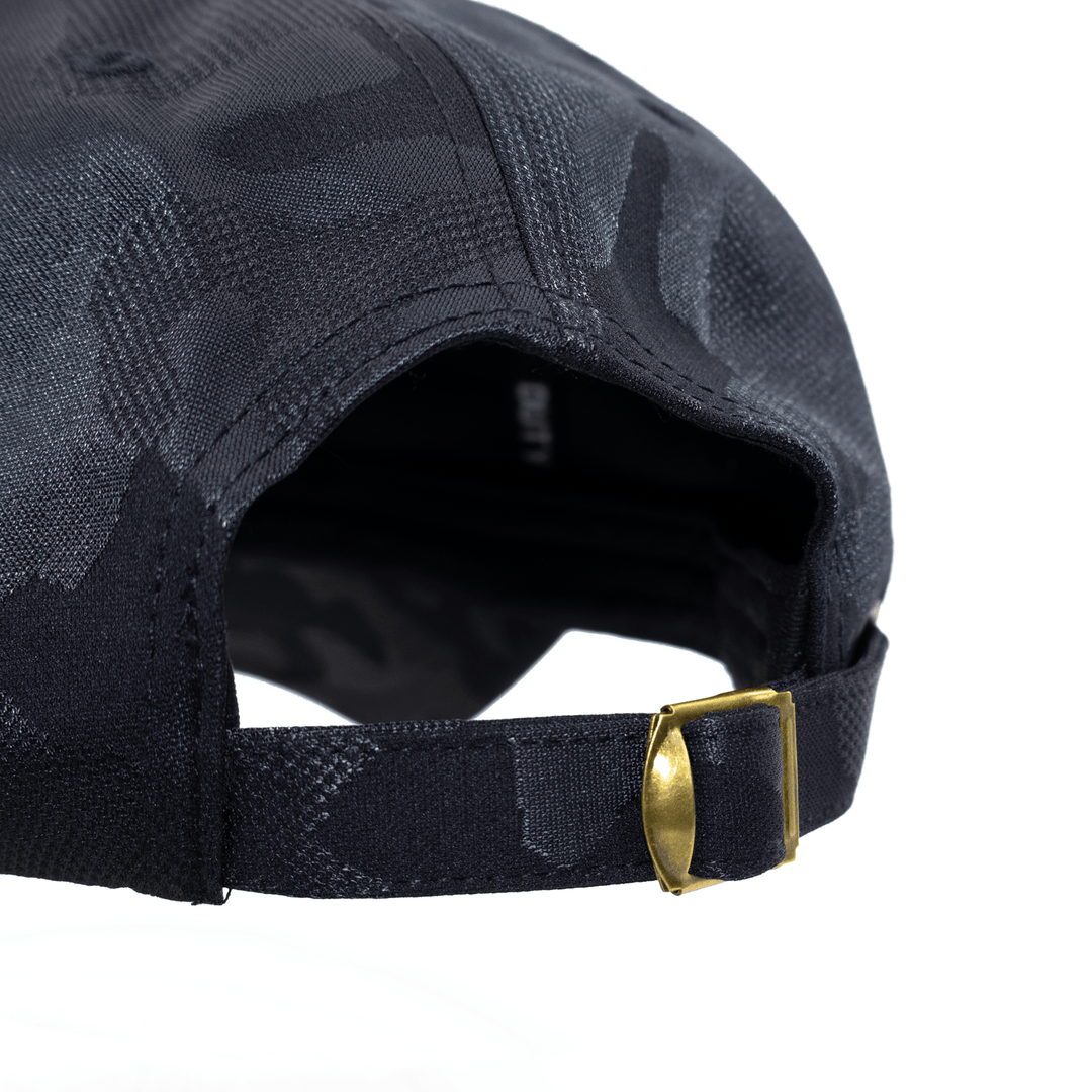 Back view of West Point hat in black camo featuring an adjustable brass buckle. 