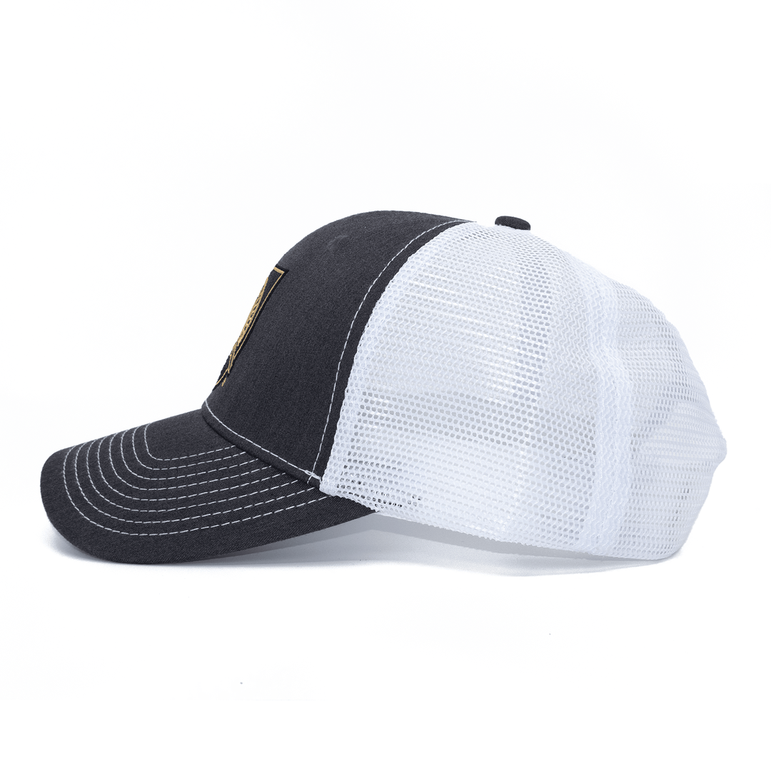 Left side view of grey and white West Point hat with Black Knights shield logo embroidered on the front