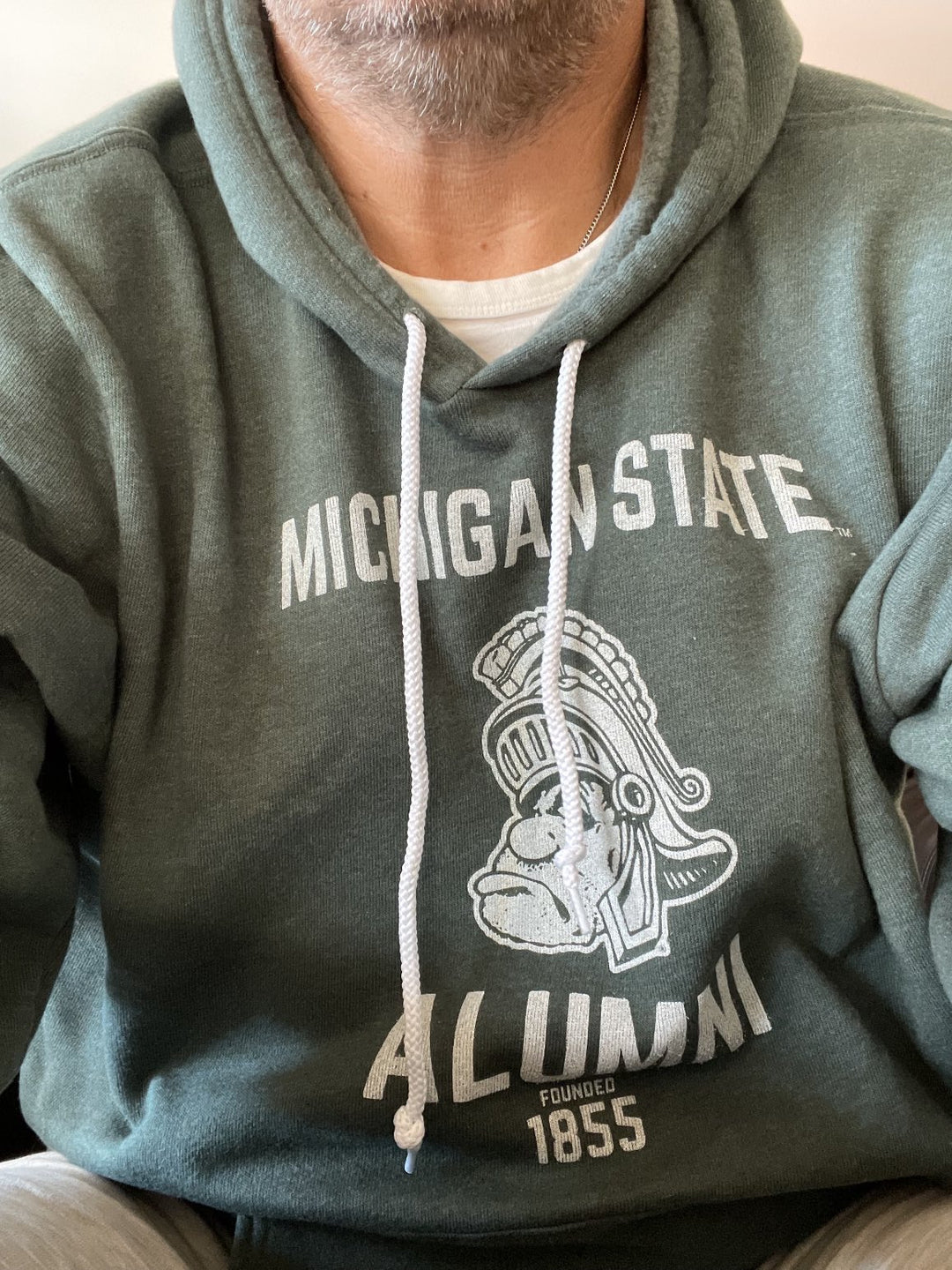 Lifestyle photo of green Gruff Sparty Michigan State Sweatshirt