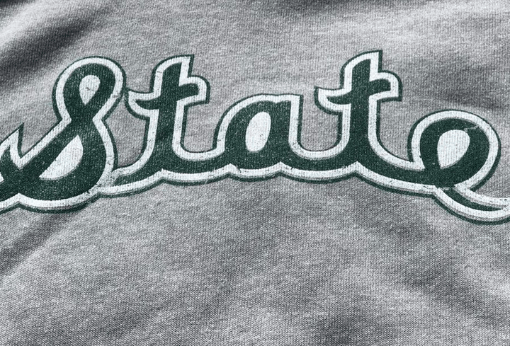 Close up of Michigan State Hoodie with Cursive State script logo